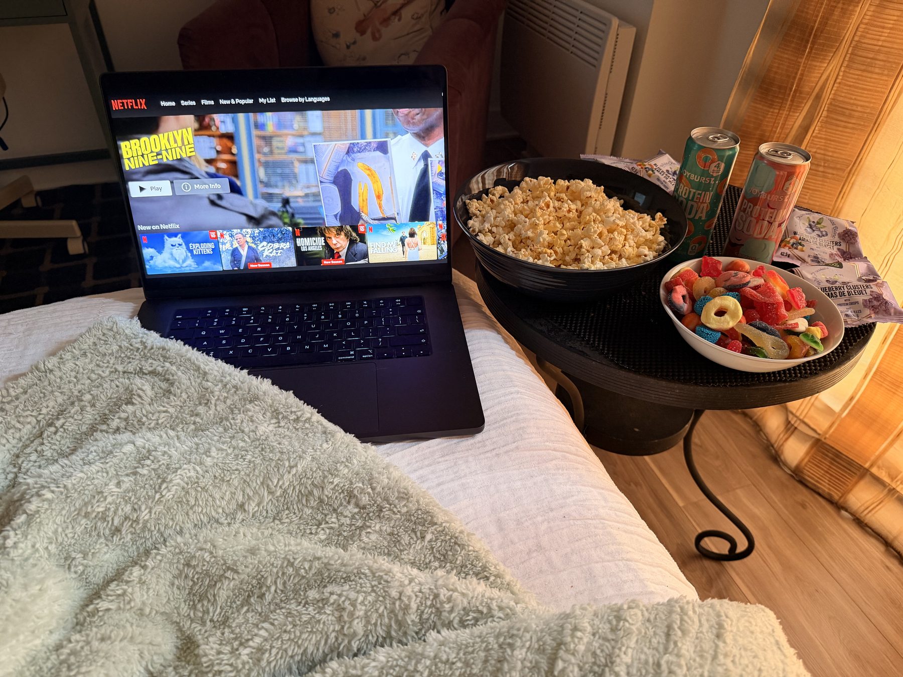 Movie night at the chalet with popcorn, candy, drinks and a blanket